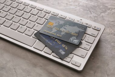 Credit cards with computer keyboard on grunge background. Concept of online banking