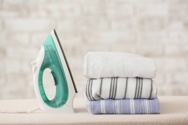 Modern iron and laundry on board in room