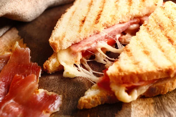 Tasty sandwiches with cheese and meat on table, closeup — ストック写真