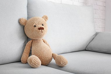 Cute baby toy on sofa