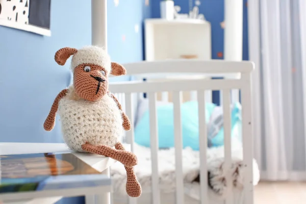 Cute baby toy on shelf in room — Stock Photo, Image