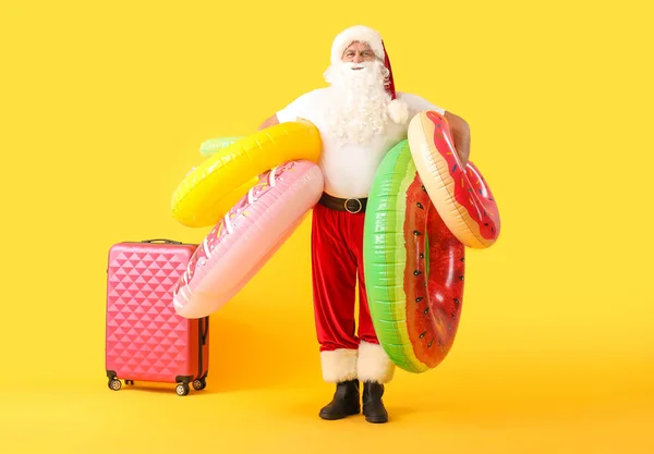 Santa Claus with swimming rings on color background. Concept of vacation — Stock Photo, Image