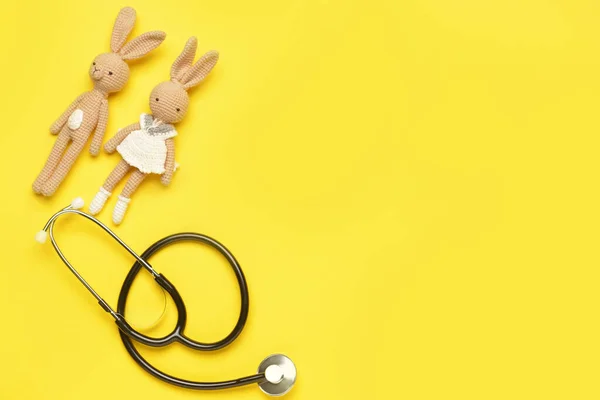 Stethoscope and baby toys on color background — Stok fotoğraf