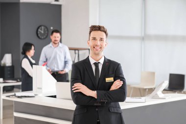 Portrait of male receptionist in office