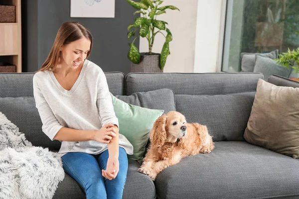 Scratching young woman with pet allergy at home — Stock Photo, Image