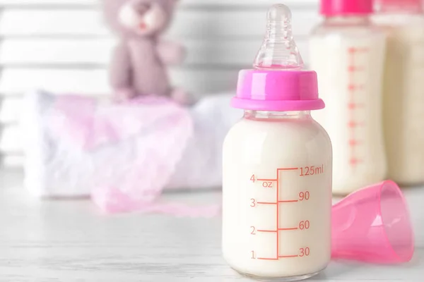 Bottle of milk for baby on white table — Stock Photo, Image