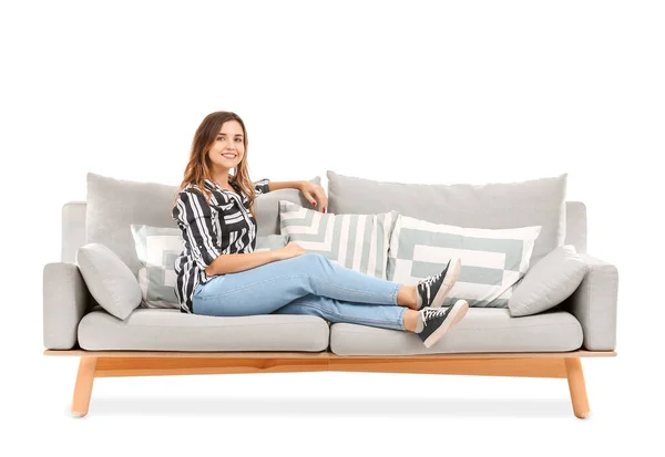 Fiatal nő pihentető kanapén fehér háttér — Stock Fotó