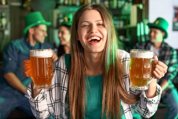 Νεαρή γυναίκα με μπύρα γιορτάζει την ημέρα του Αγίου Πατρικίου στην παμπ — Φωτογραφία Αρχείου