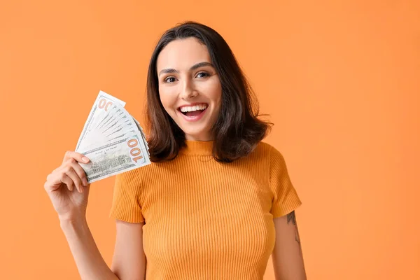 Beautiful young woman with money on color background — Stock Photo, Image