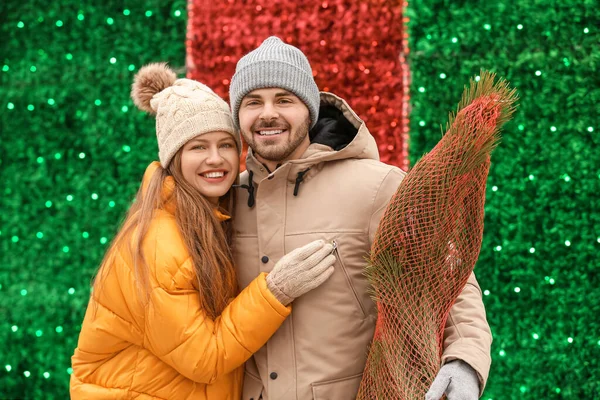 Young couple with bought Christmas tree outdoors — Stock Photo, Image