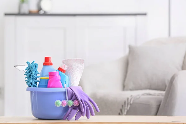 Set of cleaning supplies on table in room — Stock Photo, Image