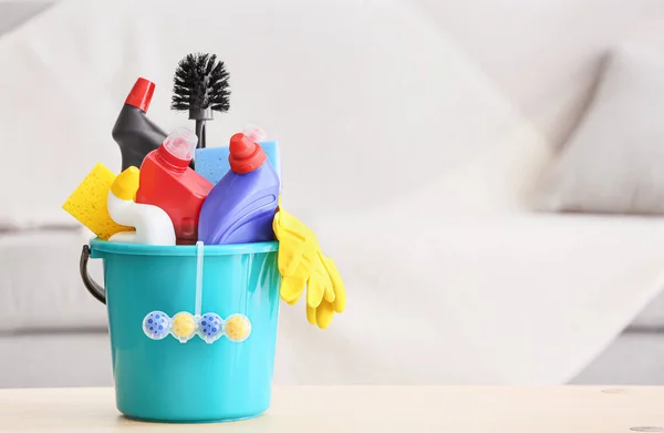 Set of cleaning supplies on table in room — Stock Photo, Image