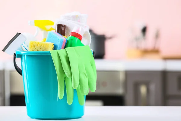 Set of cleaning supplies on table in kitchen — Stock Photo, Image