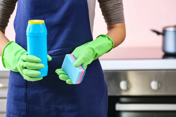 Janitor with cleaning supplies in kitchen, closeup — Stock Photo, Image