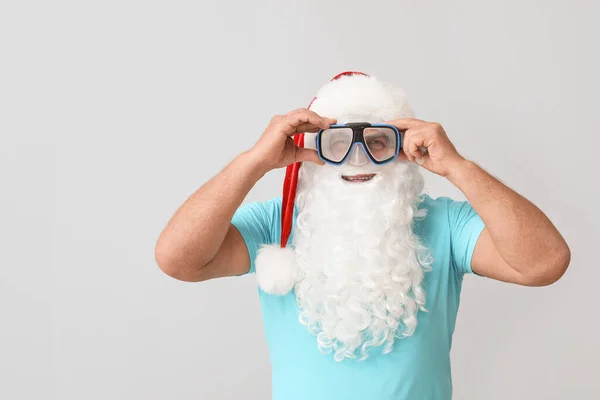 Santa Claus with snorkeling mask on light background. Concept of vacation — Stock Photo, Image