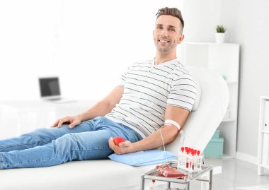 Man donating blood in hospital clipart