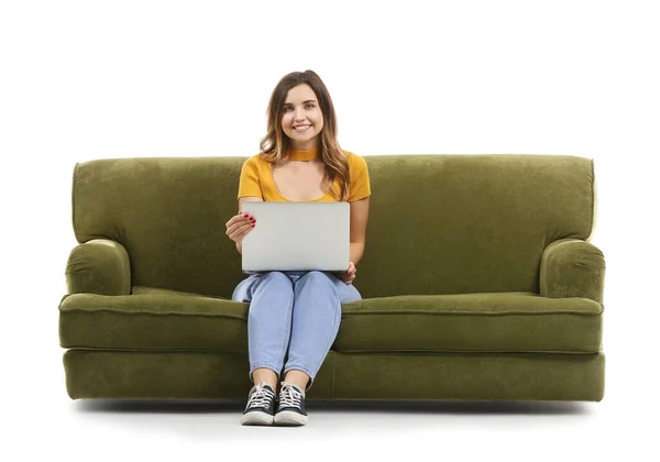 Fiatal nő laptoppal ül a kanapén fehér háttér — Stock Fotó