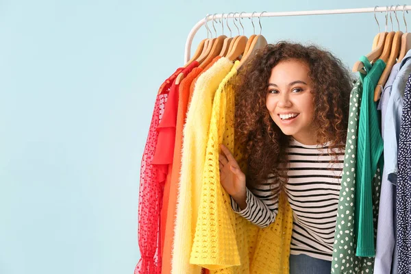 African-American stylist near rack with modern clothes — Stock Photo, Image