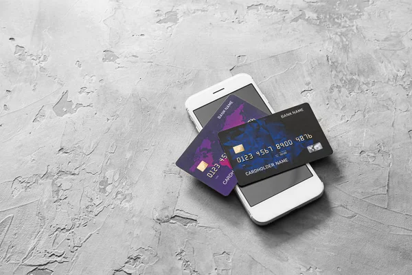 Credit cards with mobile phone on grunge background. Concept of online banking — Stock Photo, Image