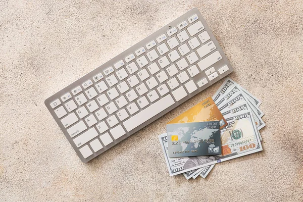 Credit cards with money and computer keyboard on grey background. Concept of online banking — 스톡 사진