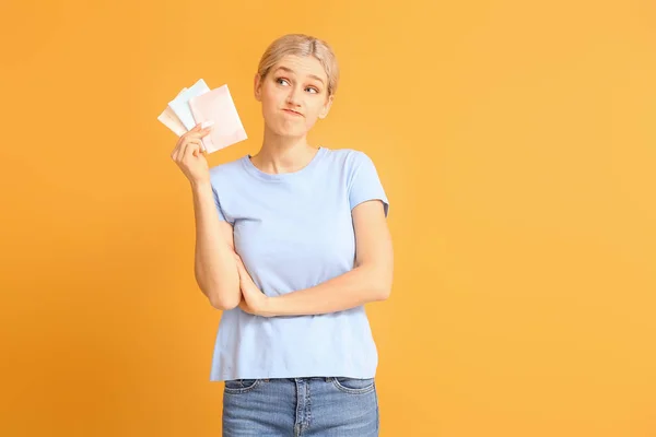 Young woman with menstrual pads on color background — Stock Photo, Image