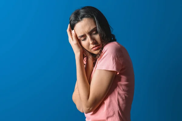 Депресивна молода жінка на кольоровому фоні — стокове фото