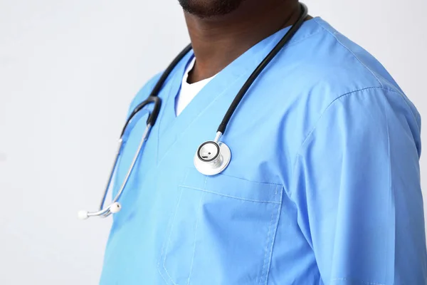 Male African-American nurse with stethoscope on light background, closeup — Stock Photo, Image