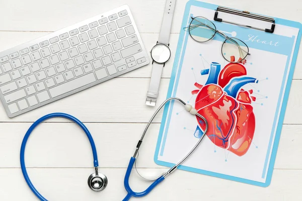 Stethoscoop met computertoetsenbord en tekening van het menselijk hart op houten tafel — Stockfoto