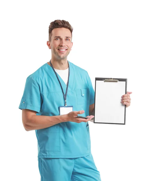 Portrait of male receptionist in medical uniform and with clipboard on white background — Stock Photo, Image