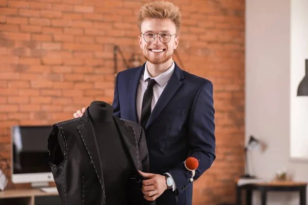 Young tailor working with mannequin in atelier — Stock Photo, Image