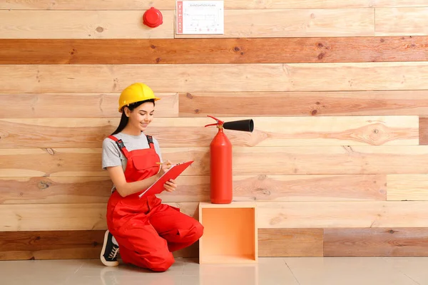 Fire safety specialist inspecting extinguisher