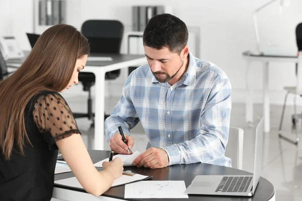 Couple signing a loan contract in bank — Stock Photo, Image