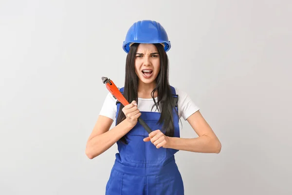 Female worker against light background. Concept of feminism — Stock Photo, Image