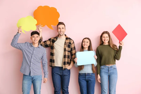 Grupa młodych ludzi z pustymi pęcherzykami mowy na tle koloru — Zdjęcie stockowe