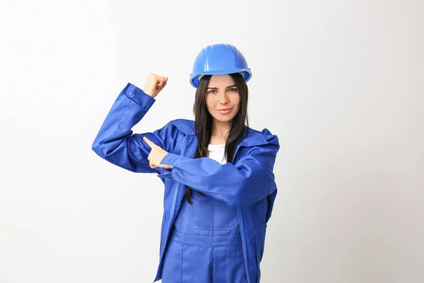 Female worker against light background. Concept of feminism — 스톡 사진