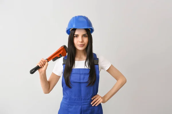 Female worker against light background. Concept of feminism — Stock Photo, Image
