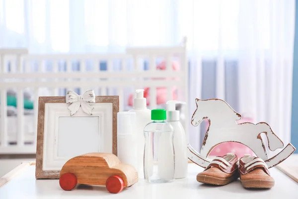 Baby toys with cosmetics on table in room — 图库照片