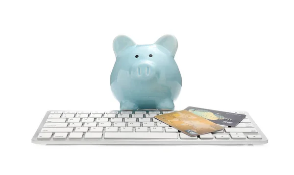 Credit cards with computer keyboard and piggy bank on white background. Concept of online banking — Stockfoto