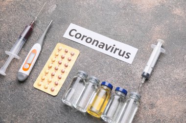 Thermometer with medicines for Coronavirus on grey background