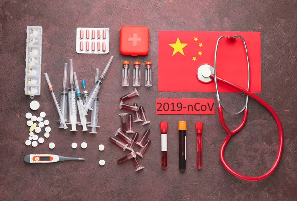 National flag of China, blood samples and medicines for Coronavirus on color background