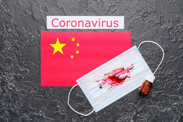 National flag of China, protective mask with blood and medicines for Coronavirus on dark background — Stock Photo, Image