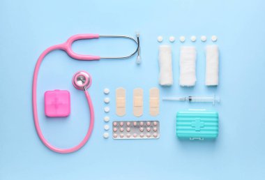 Set of medical supplies on color background