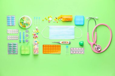 Set of medical supplies on color background