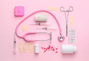Set of medical supplies on color background