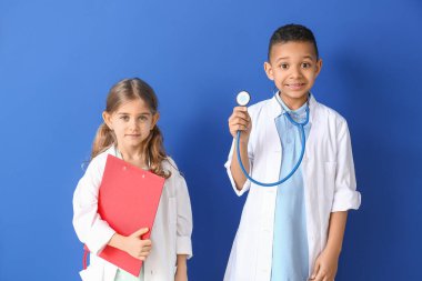 Renkli arka planda sevimli küçük doktorlar.