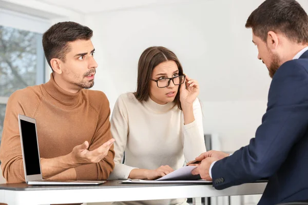 Displeased couple having meeting with bank manager in office — Stock Photo, Image