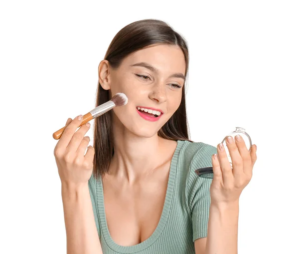 Beautiful young woman applying makeup on white background — Stock Photo, Image