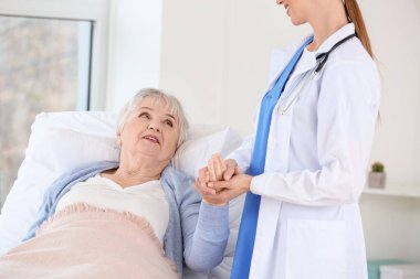 Klinikte Parkinson sendromu olan yaşlı bir kadın doktor.