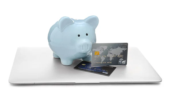 Credit cards with piggy bank and laptop on white background. Concept of online banking — Stok fotoğraf