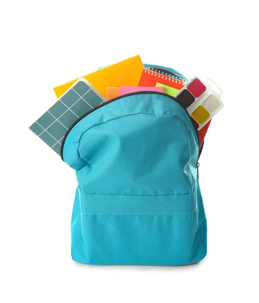 School backpack with stationery on white background — Stock Photo, Image